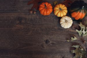 fall-decor-and-pumpkins-on-wooden-tabletop