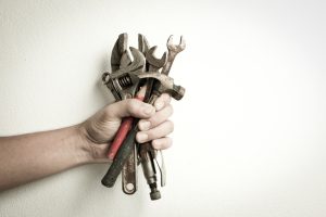 hand-holding-old-rusty-tools